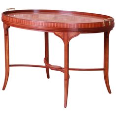 a wooden table with a glass top on it's legs and an oval shaped base