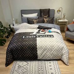 a bed with louis vuitton on it in a bedroom