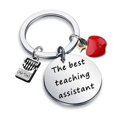 the best teaching assistant keychain has a red apple on it's side