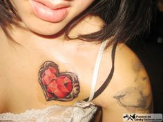 a woman with tattoos on her chest has a heart