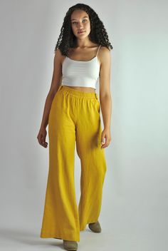 "This is our no. 83 of our Conscious Clothing Concept. This fantastic summer sunny yellow loose fitting elasticated pants are made of pure softened European linen. They are great for a casual style as well as the elegant evening. Very cconfident and elegant summer look. It has got 2 pockets on the back and 2 pockets on the sides. It is the ultimate fabric for hot weather as it breathes and absorbs moisture better that any fabric on earth. This time the fabric is heavier that usual, which makes t Summer Wide Leg Pants With Pockets, Summer Relaxed Fit Wide Leg Flare Pants, Summer Flare Wide Leg Pants With Relaxed Fit, Summer Wide Leg Pants With Loosely Fitted Hips, Yellow Wide Leg Pants With Elastic Waistband, Yellow Straight Pants With Elastic Waistband, Yellow Pants With Elastic Waistband, Flared Solid Bottoms For Summer, Flare Bottoms In Solid Color For Summer