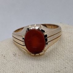 Victorian-era gold jewelry was often made in yellow gold with a soft rose gold hue. This handsome 1800s ring is crafted in 14k rosy gold that has a warm, rich appearance. The focal point is a hard-stone intaglio of a Roman soldier carved from carnelian. This ring is a generous size 12 and would make a unique wedding ring or right-hand statement ring. Please note that this ring is a true antique with over a 100-year history. You will notice in the photos there is white metal on the bottom of the Antique Red 14k Gold Signet Ring, Antique Red Signet Ring In 14k Gold, Antique 14k Gold Signet Ring With Cabochon, 1800s Ring, Roman Soldier, Unique Wedding Ring, Wedding Rings Photos, Mens Ring Sizes, Beaded Evening Bags