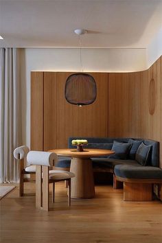 a living room filled with furniture and wooden walls