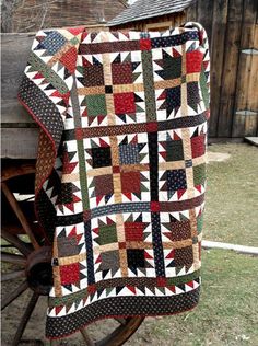 a quilt is hanging on the back of a wagon