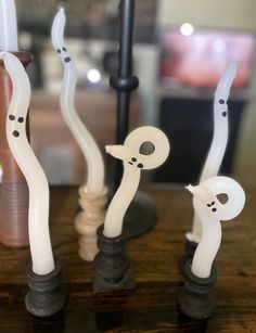 three toothbrushes with white and black designs on them sitting on a wooden table