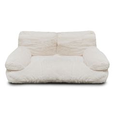 a white couch with two pillows on it