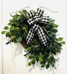 a black and white checkered bow hangs on the front door