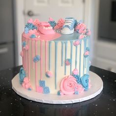 there is a cake decorated with pink and blue icing