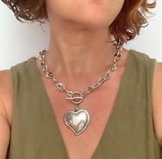 Make a bold statement with this chunky silver heart necklace, featuring a thick chain and an oversized heart-shaped pendant. This piece of statement jewelry exudes contemporary elegance and is perfect for adding a touch of glamour to any outfit. Whether worn alone or layered with other pieces, this necklace is sure to stand out and make an impact. 🔸 In the photo, the model wears a necklace length of 18" / 46 cm. MADE OF: All my pieces are made of silver-plated Zamak. Have a 100% European qualit Silver Heart Necklace With Chunky Chain, Silver Heart Pendant Chain Necklace With Chunky Chain, Valentine's Day Silver Heart Necklace With Chunky Chain, Chunky Metal Necklace With Heart Pendant, Chunky Metal Heart Pendant Necklace, Chunky Heart Pendant Necklace For Valentine's Day, Chunky Heart Necklace For Valentine's Day, Heart Pendant Necklace With Chunky Chain, Silver Heart Shaped Chain Necklace With Chunky Chain