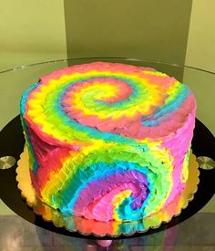 there is a cake that has been decorated with multicolored swirls on it