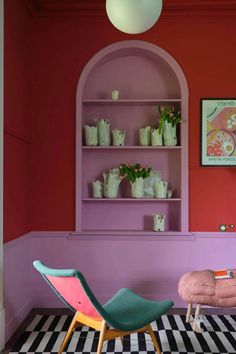 a room with pink walls and colorful furniture