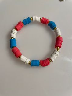 Red, white and blue preppy bracelet makes a perfect accessory to celebrate the 4th of July! Sizes teen, adult Patriotic White Stretch Bracelet, Patriotic White Stretch Bracelet With Round Beads, Adjustable White Bracelet For 4th Of July, Blue Adjustable Stretch Bracelet For 4th Of July, White Handmade Patriotic Bracelet, White Round Beads Bracelets For 4th Of July, White Round Bead Bracelets For 4th Of July, 4th Of July White Beaded Bracelets Gift, Patriotic White Handmade Beaded Bracelets