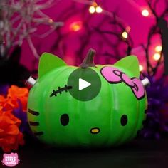 a green hello kitty pumpkin sitting on top of a table