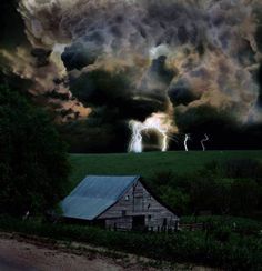 a barn in the middle of a field with lightning coming from it's clouds