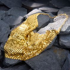 This fantastically stylish Italian necklace features gold mesh, which falls along the neckline in a triangular shape. It folds and ripples softly and beautofully, almost emulating fabric. It is crafted in solid 14k yellow gold and hangs 17 inches in length. It is finished with a lobster claw clasp. Elegant Gold Triangle Necklace, Luxury Gold Necklaces For Party, Luxury Gold Necklace For Parties, Elegant Chainmail Necklaces For Party, Elegant Chainmail Necklace For Party, Elegant Gold Bib Necklace For Evening, Elegant Gold Bib Necklace As A Gift, Mesh Jewelry, Italian Necklace