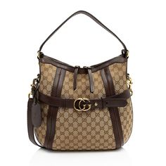 Gucci continues to reinterpret its rich heritage under current Creative Director Alessandro Michele (2015). Maintaining a balance between historical reference and contemporary eclectic flare, the brand’s signature “double g” remains iconic. Gucci has been recognized as a worldwide leader in the luxury goods market for 90 years.Condition Notes: Minor scuffs throughout exterior leather trim, handles, and shoulder strap. Surface scratches to hardware. Light marks and wear throughout interior.Width Luxury Coated Canvas Hobo Bag With Top Handle, Luxury Coated Canvas Hobo Bag With Removable Pouch, Designer Hobo Bag With Detachable Handle, Designer Rectangular Hobo Bag With Branded Hardware, Luxury Coated Canvas Hobo Bag With Leather Handles, Luxury Hobo Bag With Leather Handles And Coated Canvas, Monogram Canvas Pouch Shoulder Bag With Gold-tone Hardware, Luxury Satchel With Branded Hardware, Luxury Coated Canvas Hobo Shoulder Bag