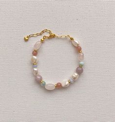 Pearl bracelet Freshwater pearl jewelry Rainbow, soft bracelet features Baroque pearls Multi-colored natural stone (pink quartz, chalcedony,larimar, kunzite and jade) Gold plated brass clasp Length - 16-22 cm(Adjustable) Pearl and stone vary in size and shape Please contact us for specific questions, size, color, etc. -Care -Delicate Jewelry, Especially Dainty Chain Designs, Should be Treated with Care While Wearing to Prevent Breakage. -Many factors can influence the condition of the jewelry. T Pastel Gemstone Beads Jewelry For Gifts, Pearl Bracelets With Natural Stones For Gift, Pearl Beaded Gemstone Bracelets As Gift, Pearl Beaded Bracelets With Natural Stones As Gift, Handmade Pastel Bracelets For Gift, Elegant Handmade Pastel Jewelry, Natural Stone Pearl Bracelet As Gift, Natural Stone Pearl Bracelet Gift, Pastel Bracelet Jewelry As Gift