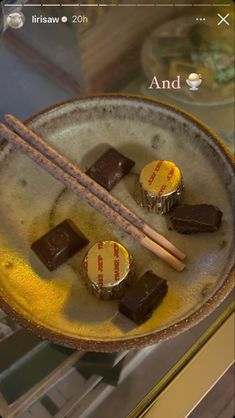 there are some chocolates on the plate with chopsticks