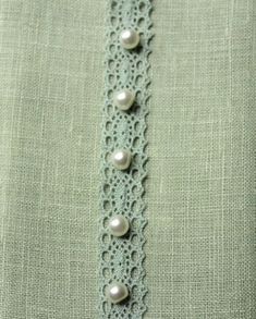 there is a lace with pearls on it