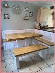 a kitchen with two benches and a clock on the wall