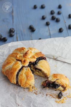 a pastry that has been cut in half and is on top of some wax paper