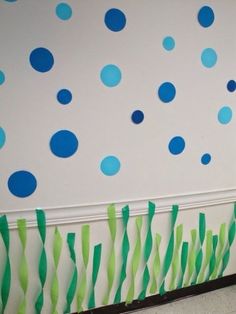 the wall is decorated with blue and green paper streamers