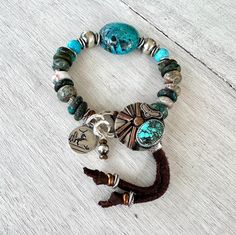 "Chunky boho bracelet, Turquoise, Jasper with Artisan Silver Button and Charm. Artisan Silver Button featuring Genuine Bao Canyon Turquoise,  Artisan Silver Charm,  Karen Hill Tribe fine silver beads, Copper beads, Bao Canton Turquoise Focal bead, Turquoise flat beads about 12 mm diameter Irregular shape natural Jasper beads about 11 mm diameter. This bracelet will fit perfect 6.5\" wrist but could be adjusted to bigger sizes with the help of a sliding silver bead placed on leather tassels." Flat Beads, Hill Tribe Silver, Aquamarine Necklace, Silver Button, Boho Bracelet, Jasper Beads, Silver Buttons, Silver Bead, Focal Bead