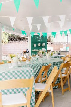 a green and white party with bunting, paper garlands and tablecloths