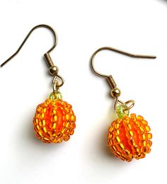 Seed bead baby pumpkin earrings are ready for fall! Show your love for fall or Halloween wearing these little cuties! Handmade with gold plated wire and Czech beads. Orange Earrings With Gold Beads As A Gift, Orange Earrings With Gold Beads For Gift, Festive Handmade Orange Earrings, Handmade Gold Earrings For Halloween, Orange Beaded Earrings With Gold Round Beads, Beaded Pumpkin Earrings, Pumpkin Bead Earrings, Handmade Gold Halloween Earrings, Beaded Pumpkin