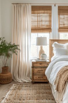 a bedroom with wicker furniture and white linens on the bed, along with bamboo blinds