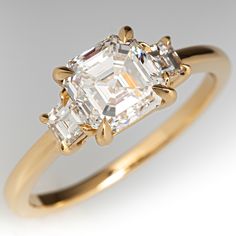 an engagement ring with two assorted cut diamonds