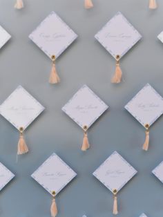 many small square white cards with tassels on them