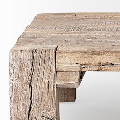 an old wooden table that has been turned into a coffee table with one leg missing