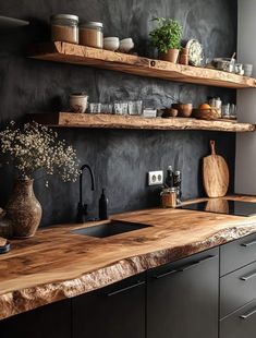 a kitchen with black walls and wooden counters