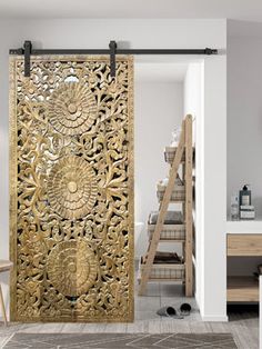 an intricately carved wooden door in a white room