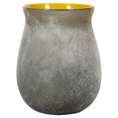 a gray vase with yellow rim sitting on a white surface