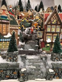 a christmas village is shown with snow on the ground