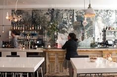 two people sitting at a bar in a restaurant