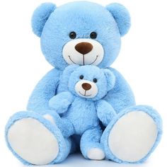 two blue teddy bears sitting next to each other on a white background with one holding the other