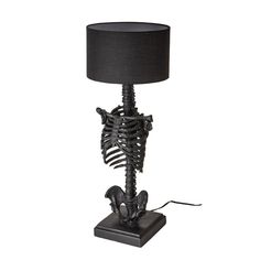 a skeleton lamp with a black shade on it