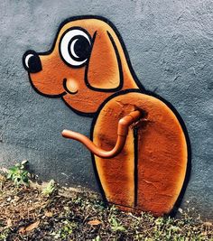 a dog painted on the side of a wall with an umbrella in it's mouth