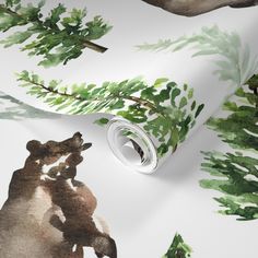 a wallpaper with green leaves and bears on it's side, next to a roll of tape