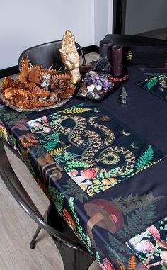 the table is covered with an elaborately designed cloth