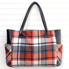 a plaid purse hanging on the wall