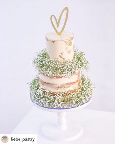 a three tiered cake with white frosting and green sprinkles