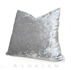 a silver velvet pillow on a white background