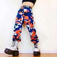 Vintage Dead Stock (New Without Tags) Mega High-Waisted Orange Camo Utility Cargo Pants. Unisex! Marked Size M. Will Fit 28"-34" Due To Adjustable Cinchs At Waist. (See Pic, Adjusted At Min & Max). These Baddies Make Your Bum Look So Darn Good. The Fabric Is Sturdy, And Denim-Like. Belt Loops (For Cinch Of Your Choice), Pockets Galore, And Button Front Close. Yup! We Love Real Pockets! Don't Sleep On These, Promise You Will Love Them! I Thought I Was Out Of These, Only 3 Left! Measurements Flat: Multicolor Streetwear Bottoms For Fall, Multicolor Bottoms For Streetwear In Fall, Multicolor Bottoms For Fall Streetwear, Multicolor Fall Streetwear Bottoms, Multicolor High Rise Bottoms With Pockets, Multicolor High-rise Bottoms With Pockets, Casual Orange Cargo Pants For Streetwear, Orange Streetwear Pants With Elastic Waistband, Fitted Orange Bottoms For Streetwear