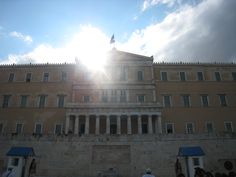 the sun shines brightly in front of an old building