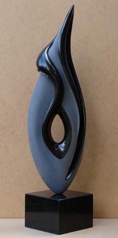 a black and blue sculpture on a stand