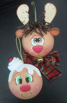 an ornament shaped like a reindeer and a bauble hanging from a string